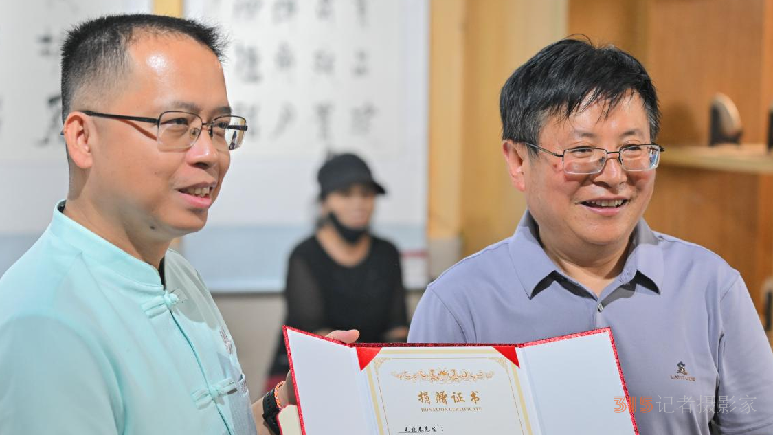 刀海清為毛曉春頒發(fā)捐贈證書